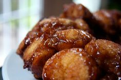 some fried food on a white plate with syrup drizzled over the top