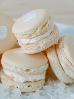 several macaroons are stacked on top of some shredded white rice in a bowl