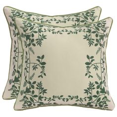 two pillows with green leaves on them