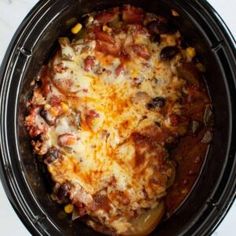 a crock pot filled with food sitting on top of a table