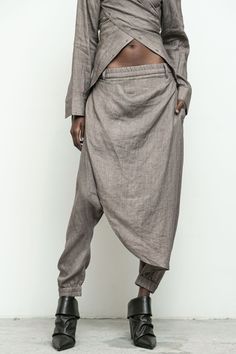 100% linen/ elastic waistband and cuff/ asymmetrical skirt overlay with button closure/ side and back pockets Jimai is 5'10" size 2 wearing size S Asymmetric Pants, Linen Pants Outfit, Taupe Fashion, Pants Linen, Knit Bottom, Asymmetrical Skirt, Linen Skirt, Bohemian Clothes, Linen Top