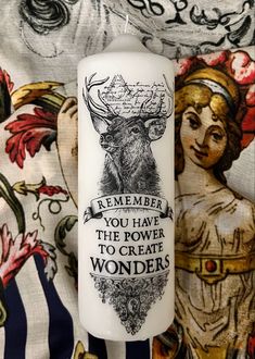 a white candle with an image of a deer on it and the words, remember you have the power to create wonders