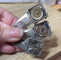 a person is holding three different types of mechanical watch movement rings in their hands,