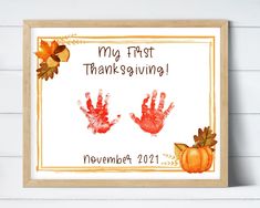 a handprint is displayed in front of a frame with the words, my first thanksgiving november 2012