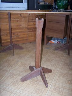 a wooden table sitting in the middle of a living room next to a tv set