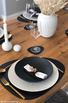 black and white place settings on a wooden table