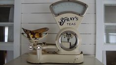 an old style coffee grinder sitting on top of a counter