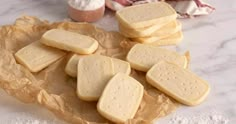 some crackers are on a piece of wax paper next to an egg and other ingredients