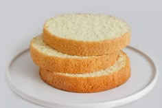 three pieces of bread stacked on top of each other in front of a white plate