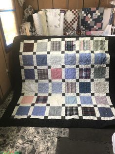 a quilt is displayed on the back of a couch