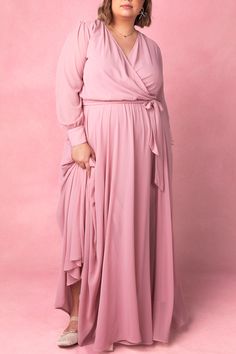 Say hello to the Andie Dress in Blush. Dare we say she's the perfect mother of the bride dress?! She's an amazing blend of style and comfort. This maxi dress features a soft pink base with a flattering faux wrap bodice and elastic waist for a flattering fit. The functional pockets and lined bodice and skirt add practicality, while the fabric's stretch makes it suitable for both maternity and nursing. With a v neckline and long, unlined sleeves, this dress is versatile AND chic. Pink Floor-length Flowy Dress, Pink Floor-length Dress With Flowy Skirt, Flowy Floor-length Pink Dresses, Feminine Flowy Floor-length Dress, Feminine Floor-length Dress With Flowy Skirt, Floor-length Flowy Skirt Dress For Prom, Flowy Floor-length Dress For Prom, Flowy Floor-length Prom Dress, Modest Bridesmaid Maxi Dress For Spring