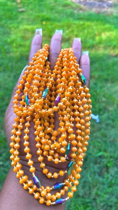 Colors:Orange, Green, Gold, Blue Features: Austrian crystal beads Traditional tie on waist beads Made on 100% African thread Size: approx. 50 inches Priced as individual strand & typically ties once around the waist Large Oval Orange Beads, Orange Faceted Beads Necklace For Party, Orange Polished Oval Beaded Necklaces, Orange Polished Beaded Necklaces, Orange Necklaces With Large Beads For Party, Orange Polished Round Beaded Necklaces, Orange Party Necklaces With Large Beads, Orange Gold Beads For Gifts, Traditional Orange Faceted Beads