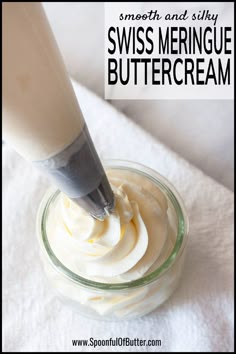 a glass jar filled with whipped cream on top of a white towel