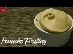 a small white bowl filled with frosting sitting on top of a wooden table next to the words panache frosting