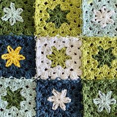 a crocheted blanket made up of squares with different colors and designs on them