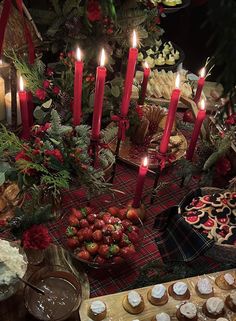 a table topped with lots of cakes and cupcakes