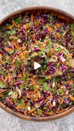 a wooden bowl filled with coleslaw and carrots