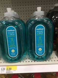 two bottles of method soap sitting on a shelf in a grocery store, one is green and the other is blue