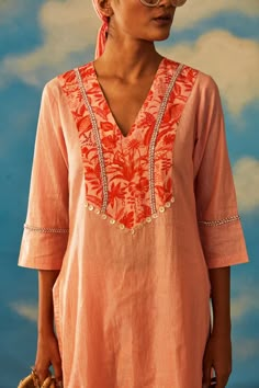 Editor's Note Featuring This Graceful Bright Coral Dove Kurt Set With Lurex As The Base Fabric. The Set Comprises Of Short Kurta With Straight Ankle Lengthpants With Additional Cut Dana Detailing On The Neckline And Hemline Of The Pants. Color: Coral Fabric: Lurex Care: Dry Clean Only About the Designer Rishi & Vibhuti label combines traditional elements with modern aesthetic uniquely to create chic occasion wear for women with a fine choice. The global appeal in their designs has made Rishi & V Modern Kurta Designs Women, Unique Kurta Designs Women, Short Kurta With Pants, Kurthi Necks, Straight Kurti Designs, Neck Design Kurti, Kurta Ideas, Suit Stitching, Small Mandala Tattoo