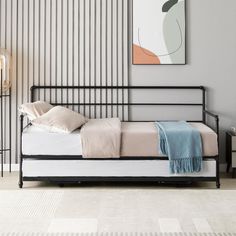 a bed sitting in a bedroom next to a painting on the wall with vertical stripes