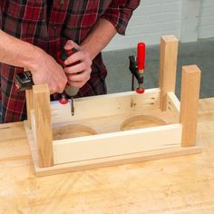 a man working with woodworking tools on a table