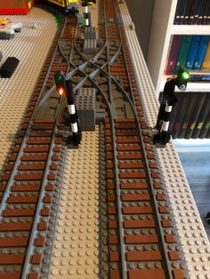 a lego train track with two lights on it