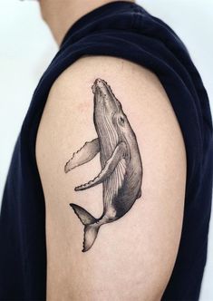 a whale tattoo on the left upper arm