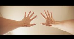 two hands reaching out towards each other