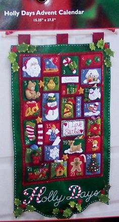 a christmas quilt hanging on the wall in front of a white door with holly days calendar