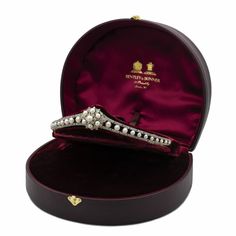 an elegant diamond and pearl brooch in a velvet case