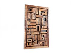 a piece of art made out of wood with different shapes and sizes on the wall