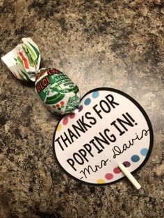 some lollipops are sitting on top of a granite counter with the words thanks for popping in