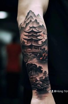 a man with a tattoo on his arm that is covered in mountains and pagodas