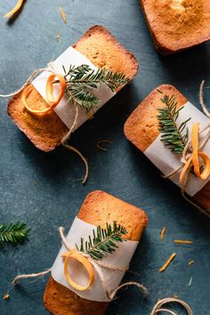 three pieces of bread wrapped in twine and decorated with orange slices