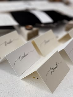 place cards with names on them sitting on a table