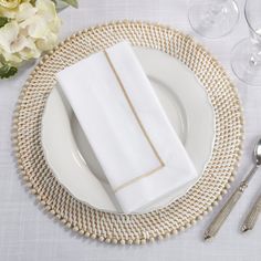 a place setting with white plates and silverware