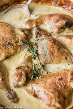 chicken with gravy in a skillet with a spoon