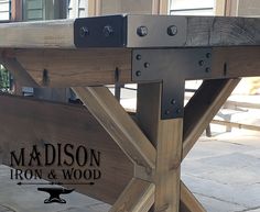 a close up of a wooden bench with metal brackets on the top and bottom part