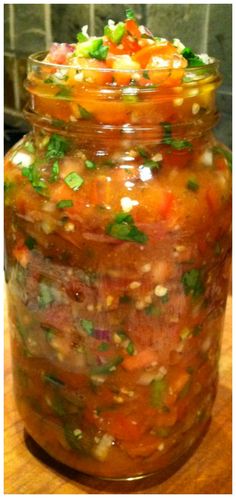 a jar filled with food sitting on top of a wooden table