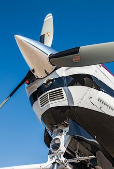 the front end of an airplane with its propeller out and it's engine visible