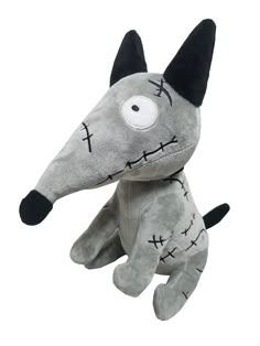 a gray stuffed animal with black ears and eyes