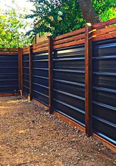 a wooden fence that is next to a tree