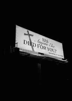 a billboard with a cross on it in the dark