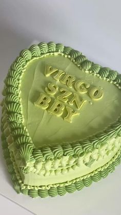 a green heart shaped cake with the words sweet baby written on it's side