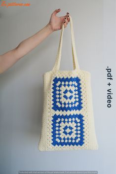 a crocheted tote bag hanging on a wall