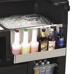 an ice chest with drinks and condiments in it