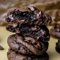 three chocolate cookies stacked on top of each other with one cookie in the middle, and two others partially eaten