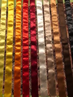 many different colored ribbons are lined up together