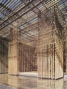 the interior of a building made out of wooden slats