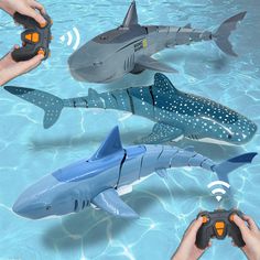 several different types of toys in the water, including sharks and shark shaped objects with hands holding remotes